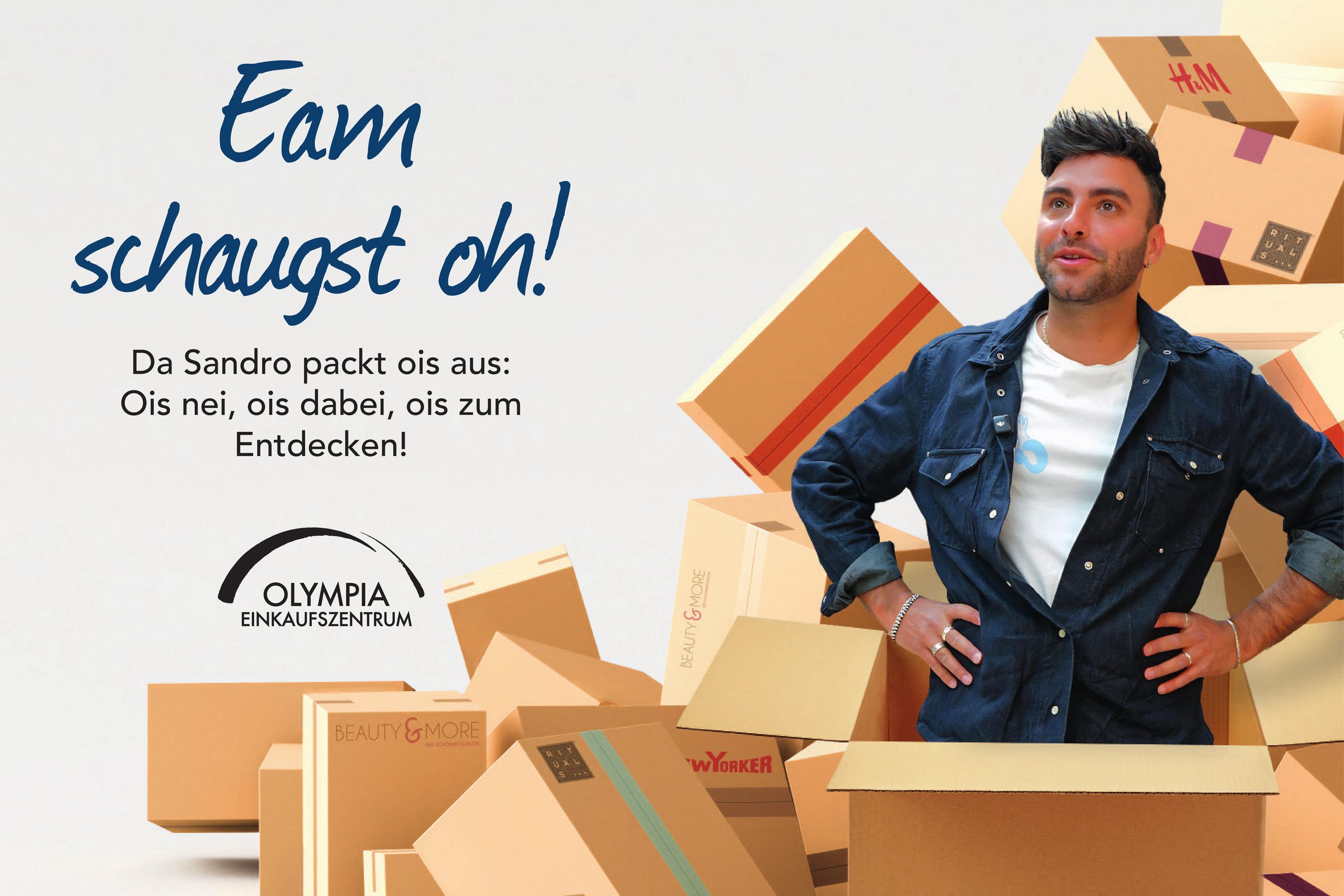 Key Visual: Sandro steht in einer Box zwischen den Paketen der neuen Stores